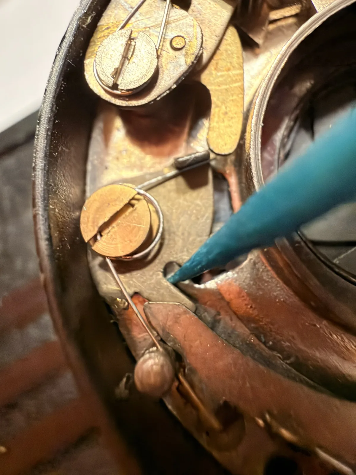 A close look at the spring area, with a tool pointing to the mechanism