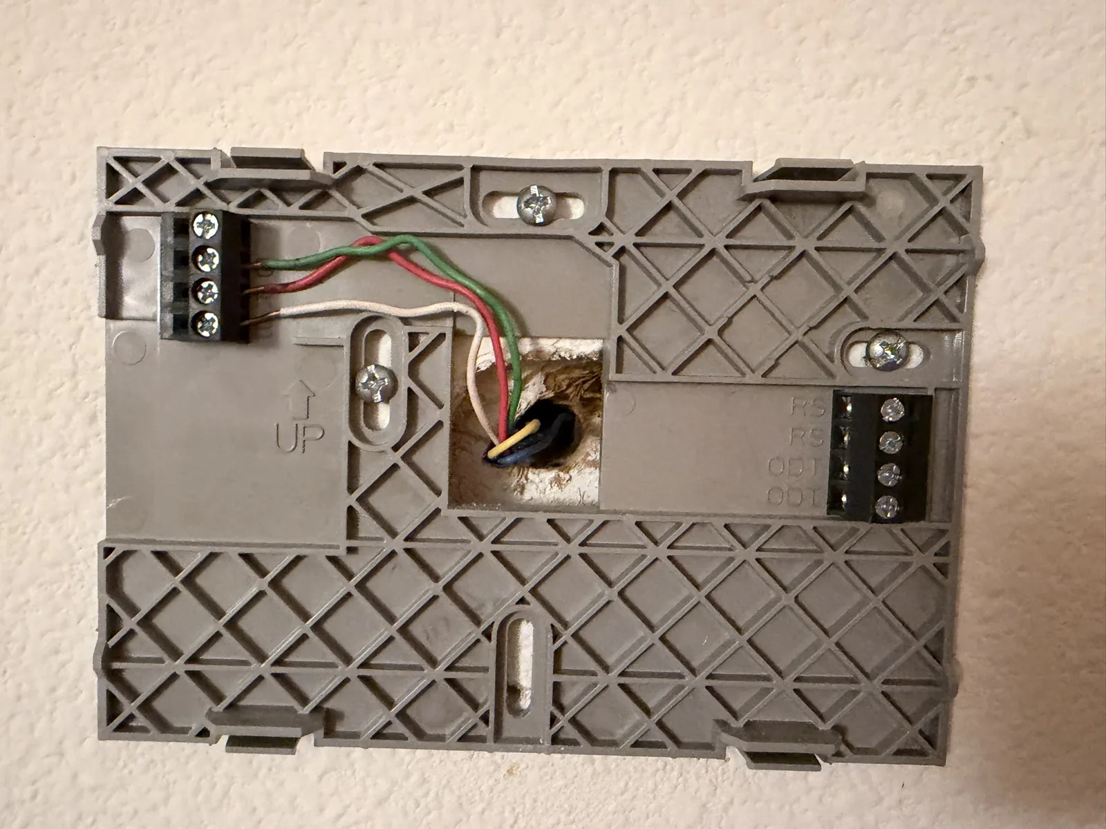 The backplate and wiring on the wall